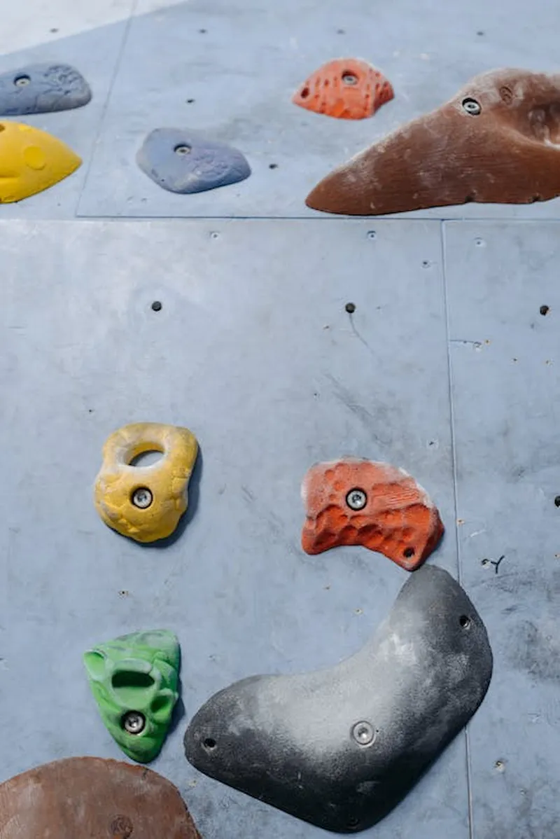 A climber chalking up below an indoor route
